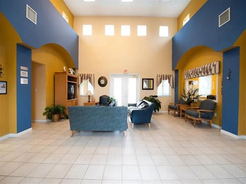A spacious waiting room with a blue and yellow color scheme.