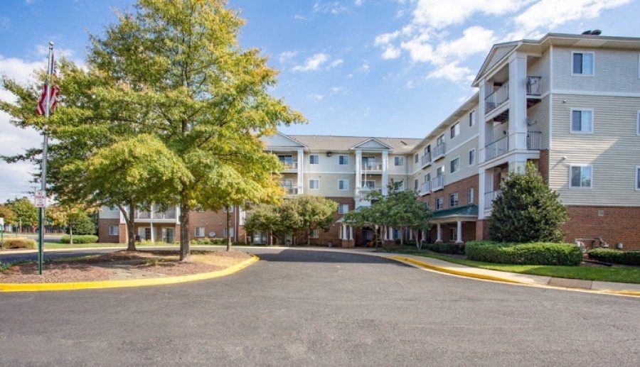 A large apartment complex with a flag flying in front of it.
