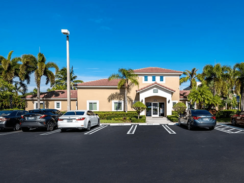 A building with a parking lot in front of it.