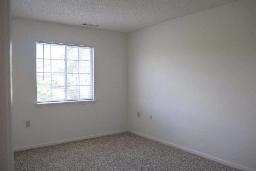 an empty room with a window and white walls at Greenbrier Seniors Apartments, Virginia, 23320
