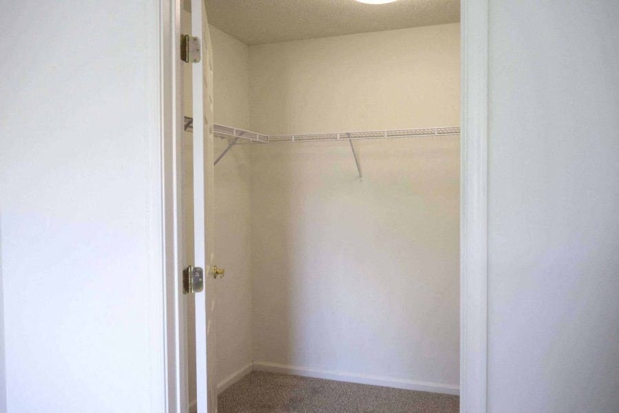 an empty closet with a white wall and a white door at Greenbrier Seniors Apartments, Chesapeake, VA 23320  