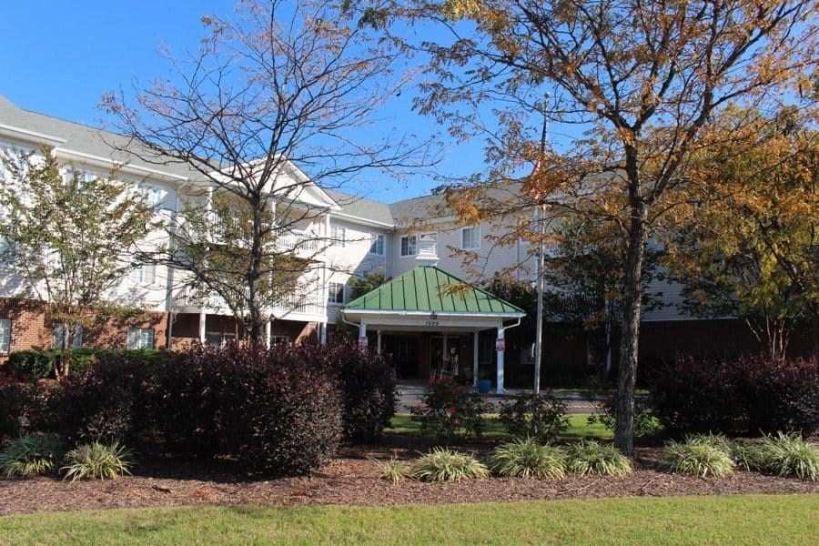 the front of a building with a green roof at Greenbrier Seniors Apartments, Chesapeake, VA 23320  
