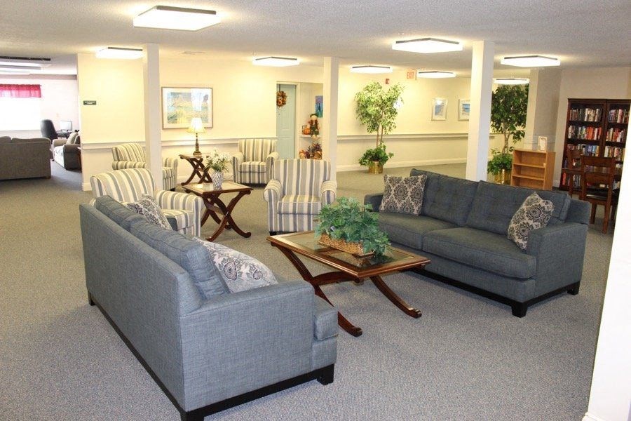 a living room with couches and chairs and a table at Greenbrier Seniors Apartments, Virginia, 23320