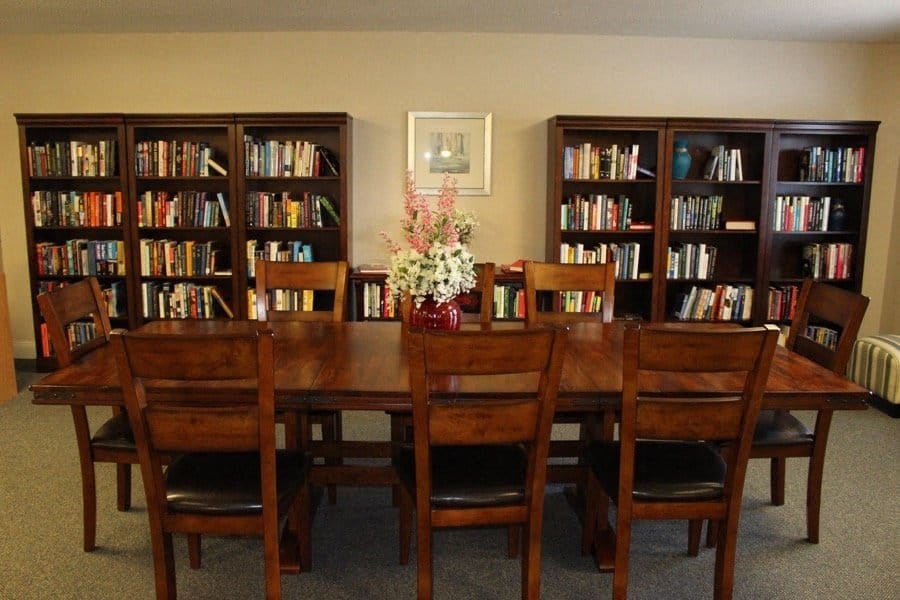 a library with a wooden table and chairs at Greenbrier Seniors Apartments, Chesapeake, 23320  