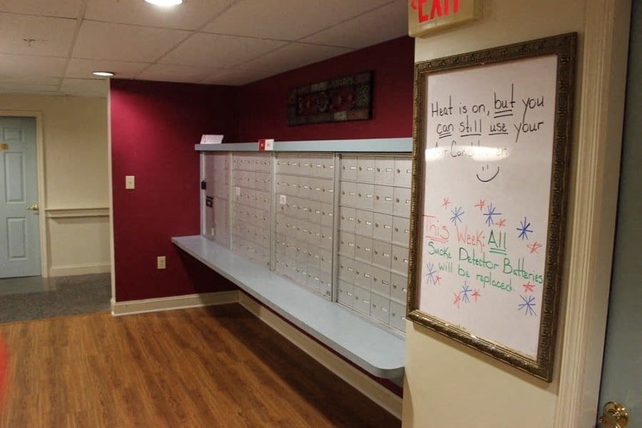 a locker room with a whiteboard and a message on the wall at Greenbrier Seniors Apartments, Chesapeake, VA 23320  