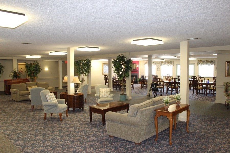 a living room with couches and chairs and tables at Greenbrier Seniors Apartments, Chesapeake 