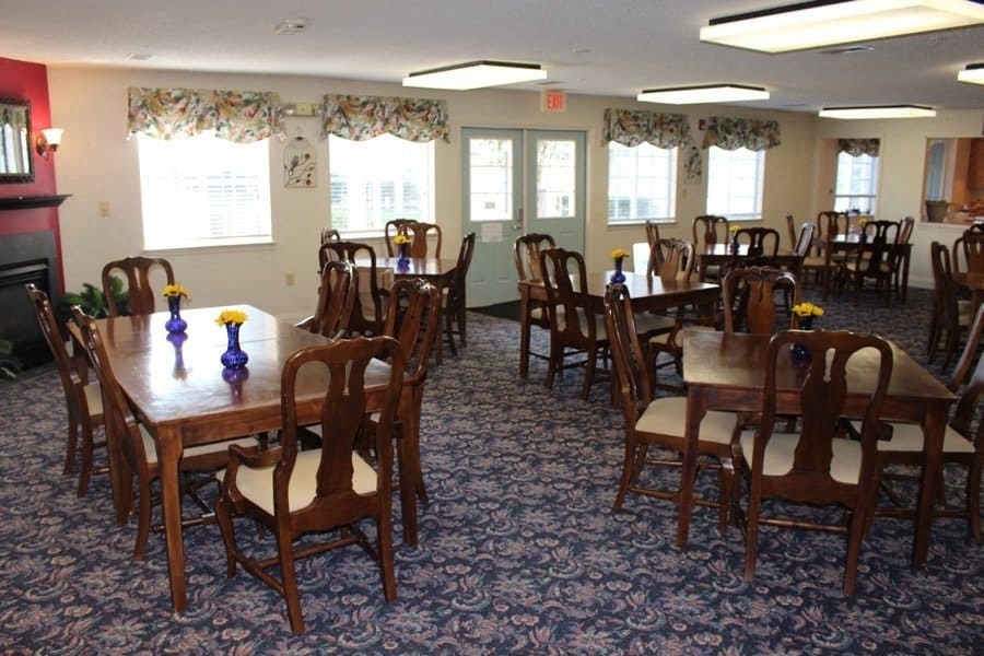 a large dining room with tables and chairs and windows at Greenbrier Seniors Apartments, Virginia, 23320