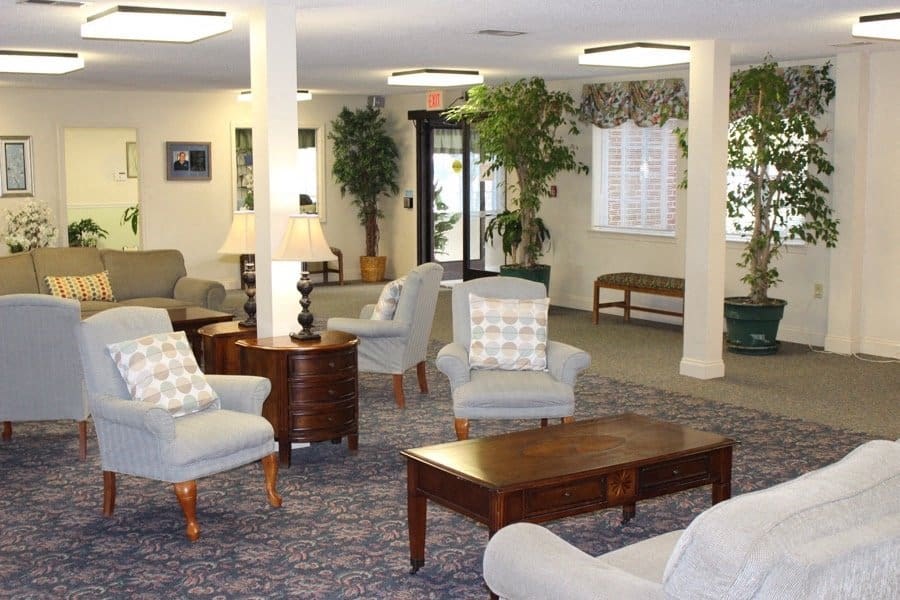 a living room with couches and chairs and a table at Greenbrier Seniors Apartments, Virginia  