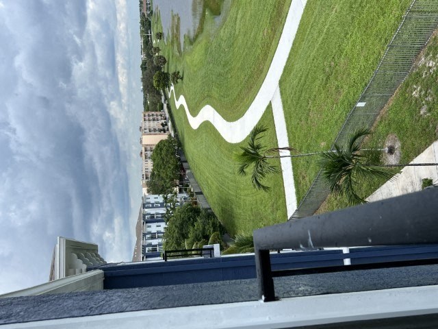 a view of a grassy field from the roof of a boat