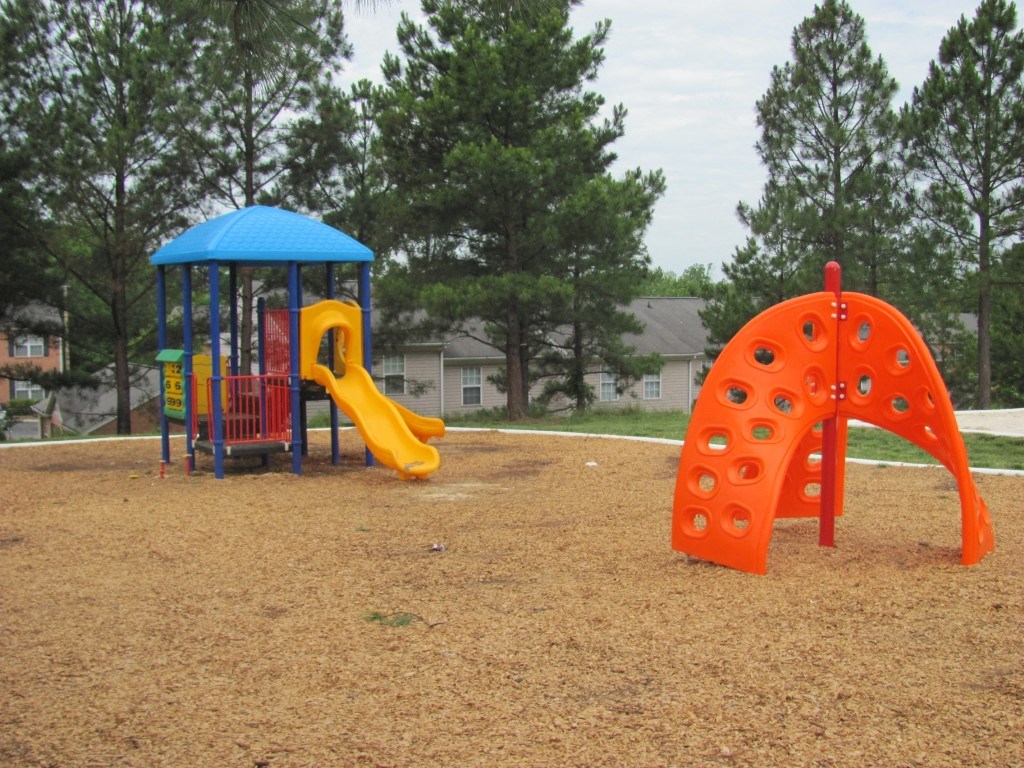 a playground with a swing set and a slide
