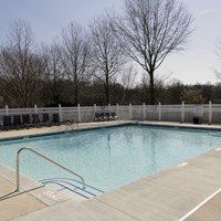 A small pool with a metal fence around it.