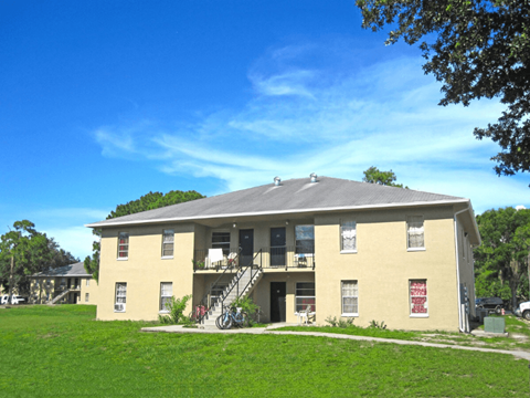 A two-story building with a balcony on the second floor.