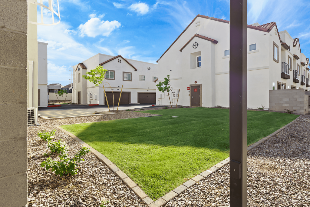 the front yard of a house with grass and a lawn