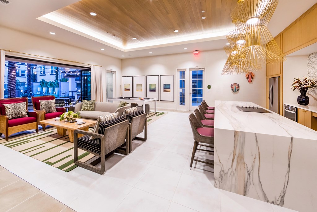 the lobby of a hotel with couches and chairs and a bar