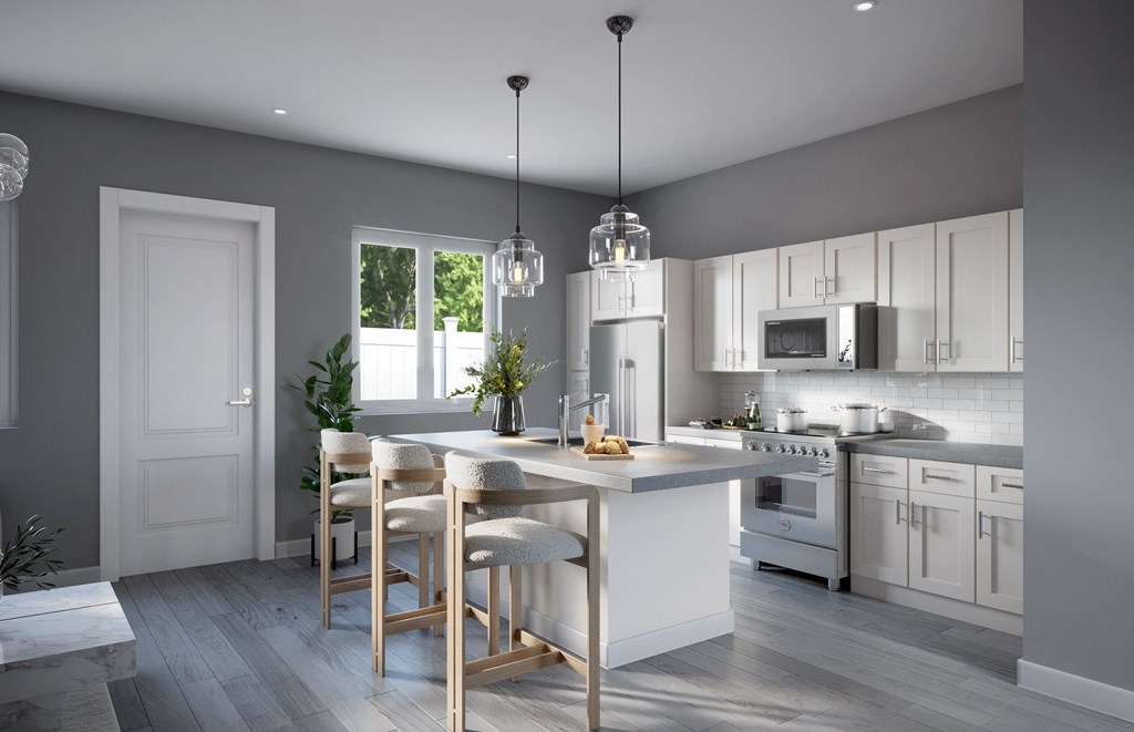 a kitchen with white cabinets and a white island with chairs