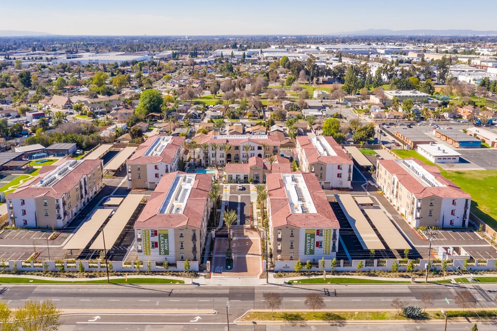 an aerial view of a city with buildings and a road