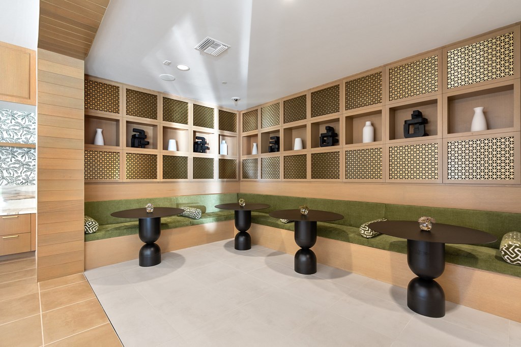 a seating area with tables and shelves in a store