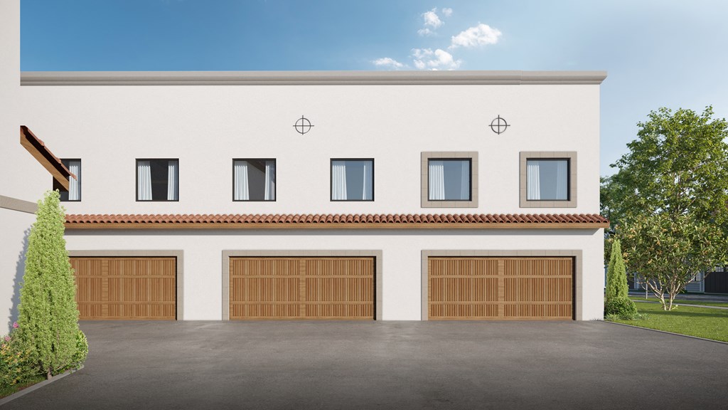 a white house with wooden garage doors