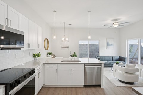 A modern kitchen with white cabinets and a large island.