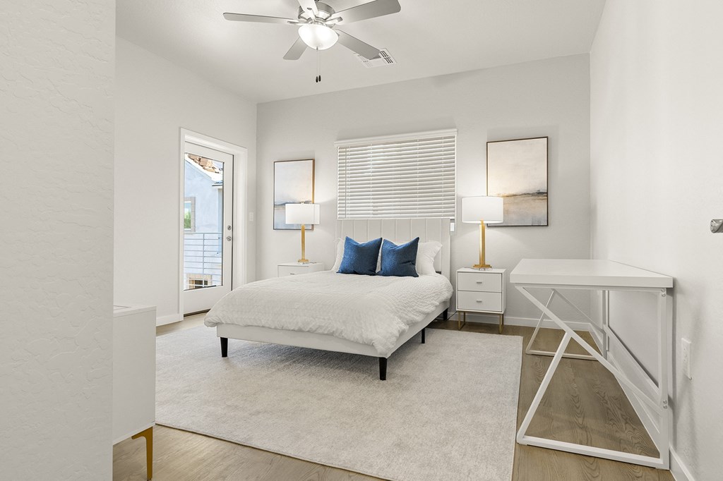 a bedroom with a bed and a ceiling fan