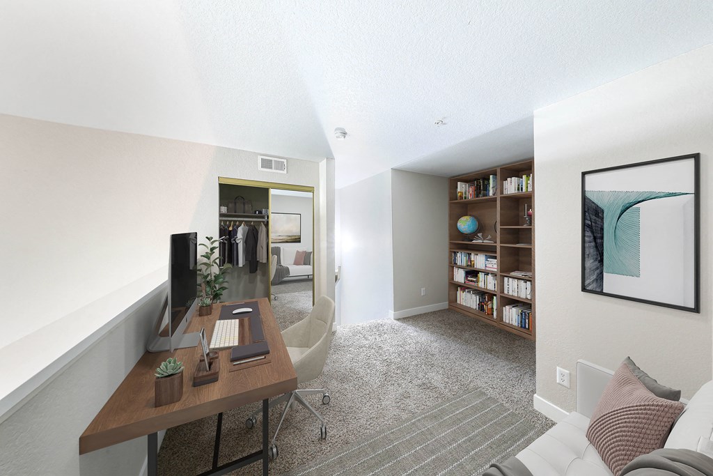a living room with a desk and a couch