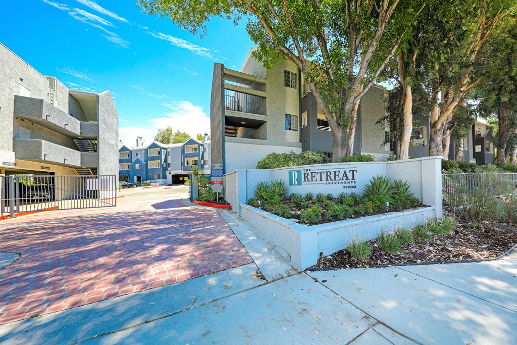 the preserve at gateway apartments entrance to the building with a gate and trees