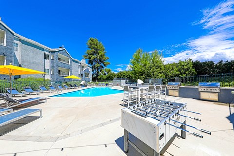 the reserve at city center apartments pool area with chaise lounge chairs