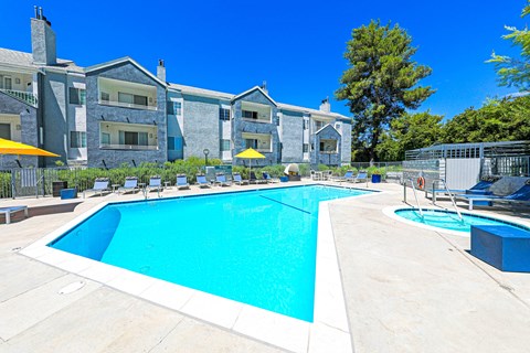 our apartments have a swimming pool with chairs and umbrellas