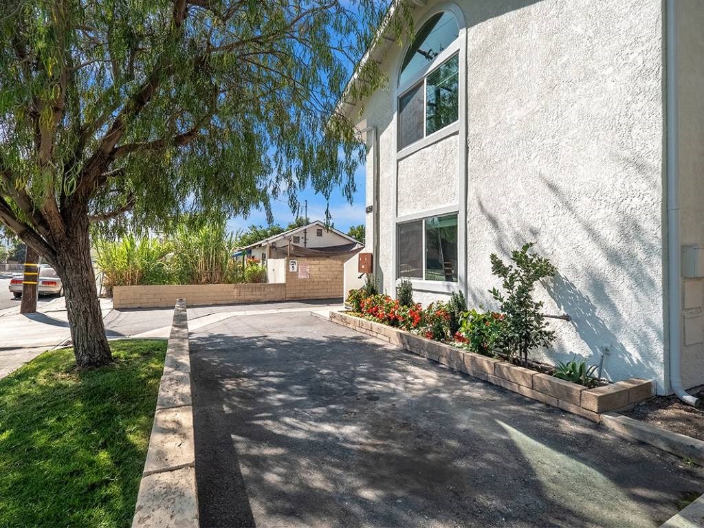 a white building with a tree in front of it