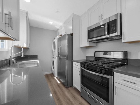 a kitchen with stainless steel appliances and white cabinets