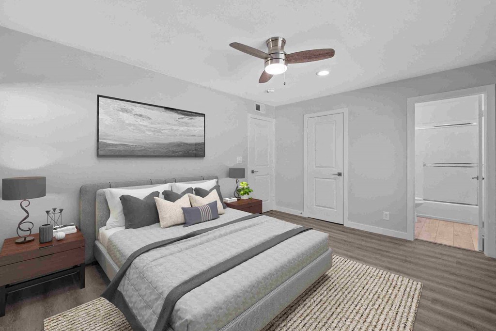 a bedroom with a large bed and a ceiling fan