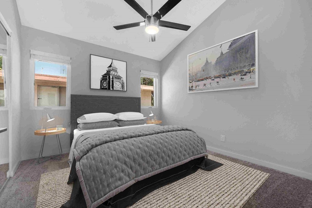 a bedroom with a bed and a ceiling fan