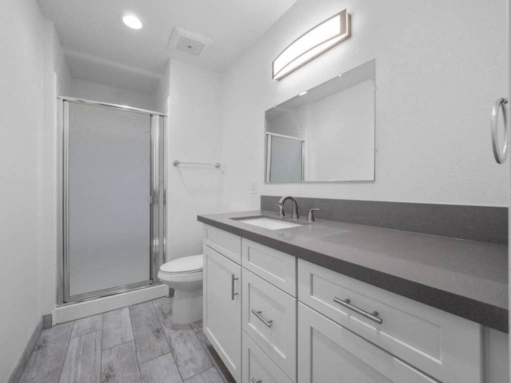 a bathroom with a sink toilet and shower