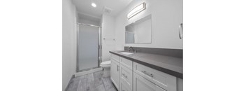 a bathroom with a toilet sink and shower