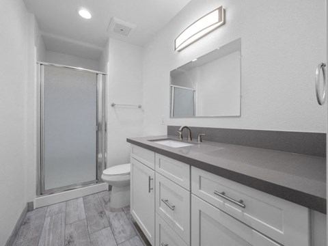 a bathroom with a toilet sink and shower