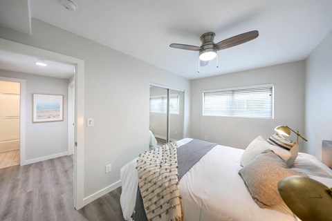 a bedroom with a large bed and a ceiling fan