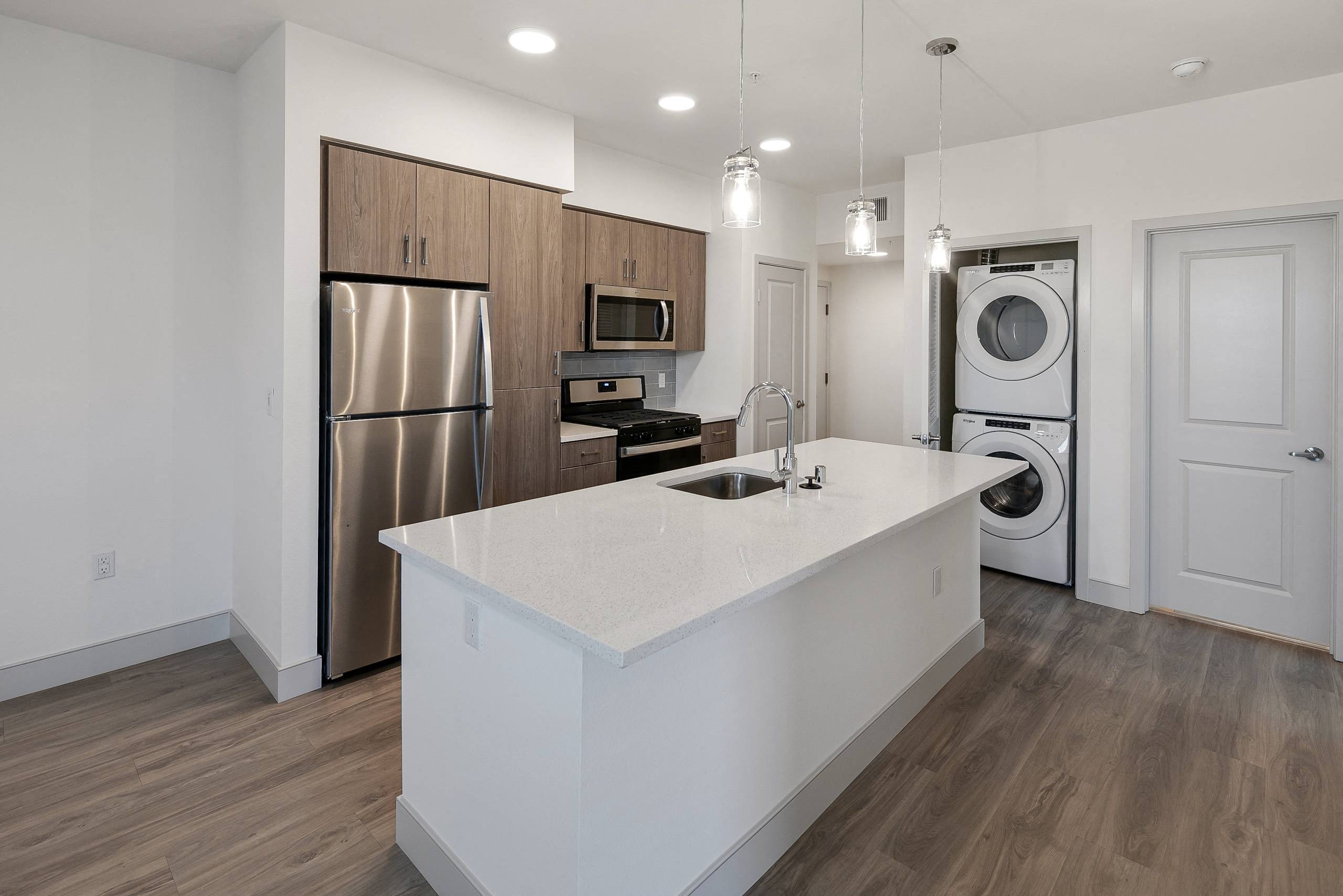 a kitchen with an island and a washer and dryer