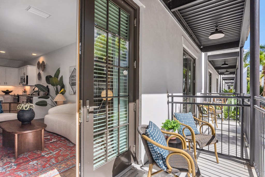 a living room with a bed and a balcony at Casa Marti, Tampa, FL