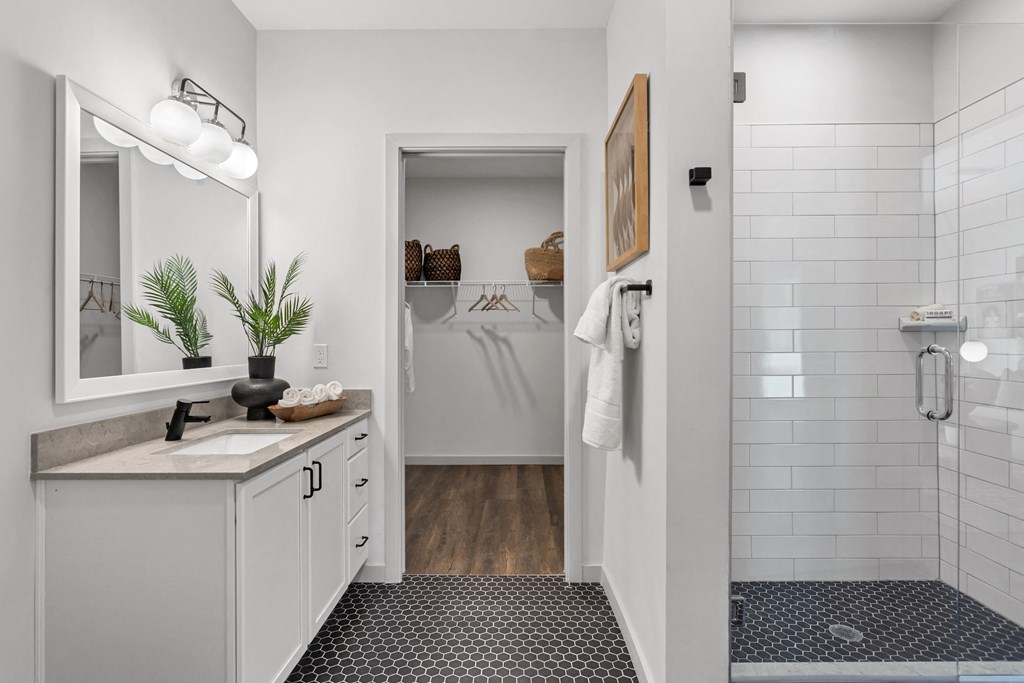 a white bathroom with a shower and a sink and a mirror at Casa Marti, Tampa