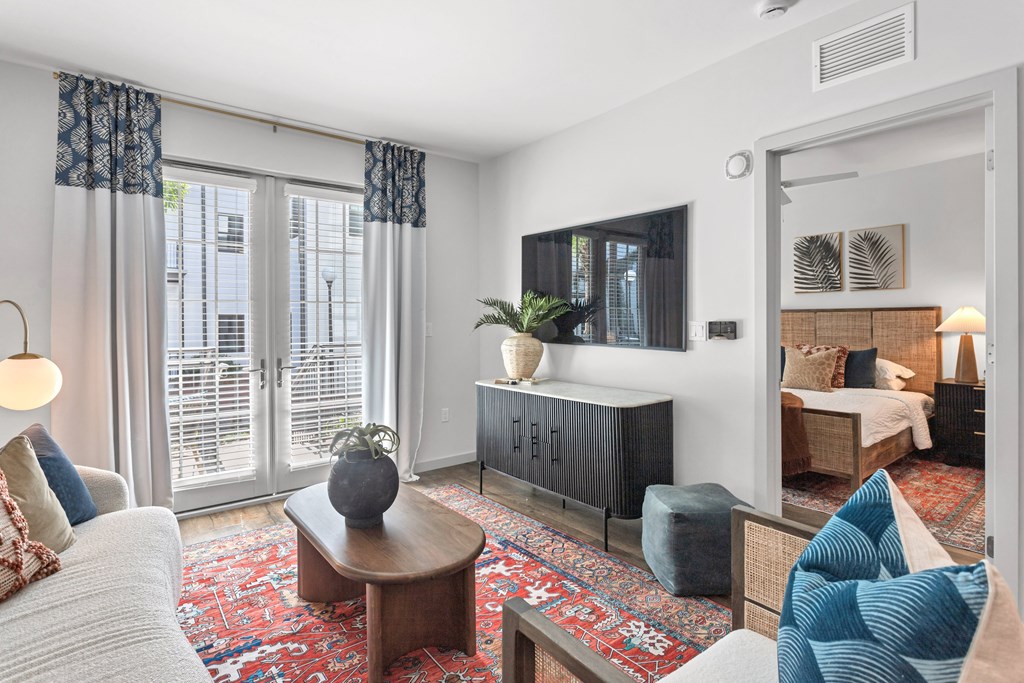a living room with a couch and a tv and a door to a bedroom at Casa Marti, Tampa, FL, 33605
