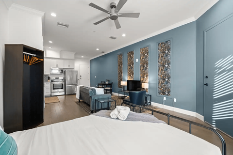 a bedroom with a bed and a living room