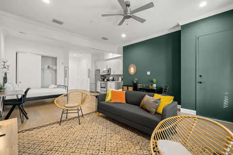 a living room with a couch and a table and a kitchen