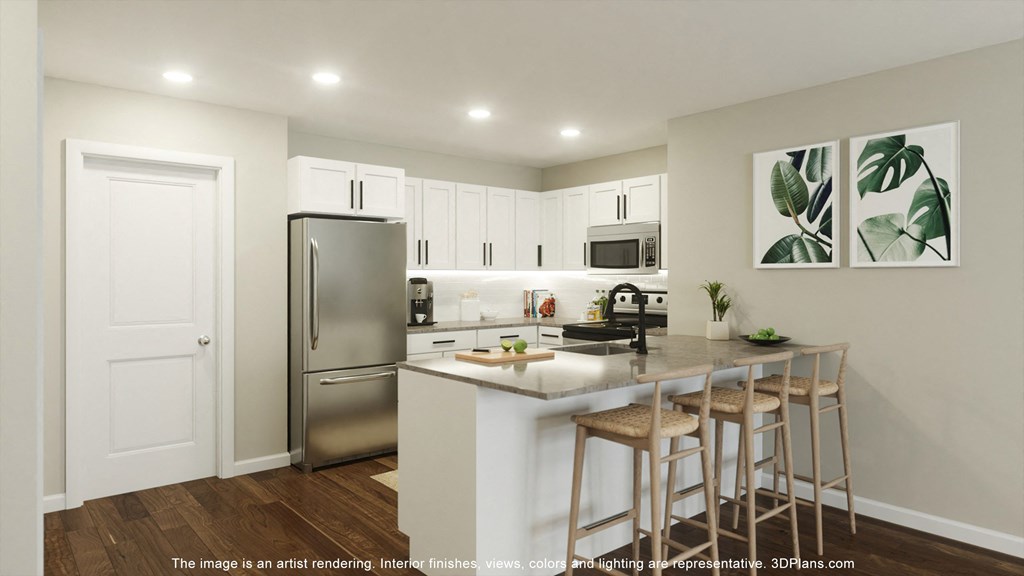 a kitchen with stainless steel appliances and a counter top with three stools at Casa Marti, Tampa, 33605