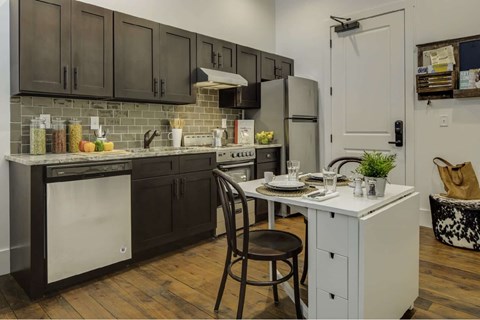 a kitchen with a island and a stove and a refrigerator