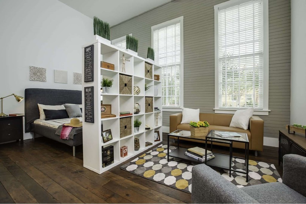 a living room with a white shelving unit