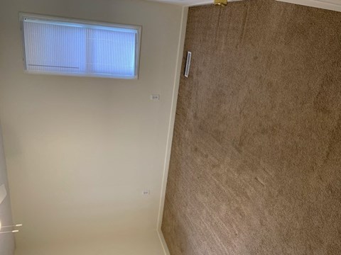 a bedroom with a window and neutral walls at Hurd & Bone Property Management, Lebanon