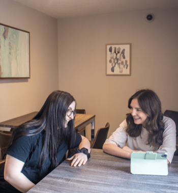 two women sitting at a table in a cafe at Campus Park, Duluth, 55811