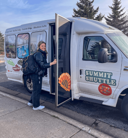 a woman is standing in the door of a van at Boulder Ridge, Duluth