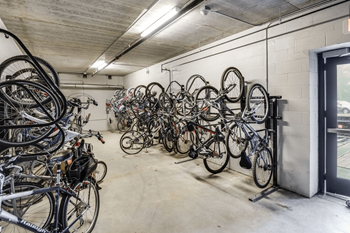 a bunch of bikes hanging on a wall in a garage at Bluestone Lofts, Duluth