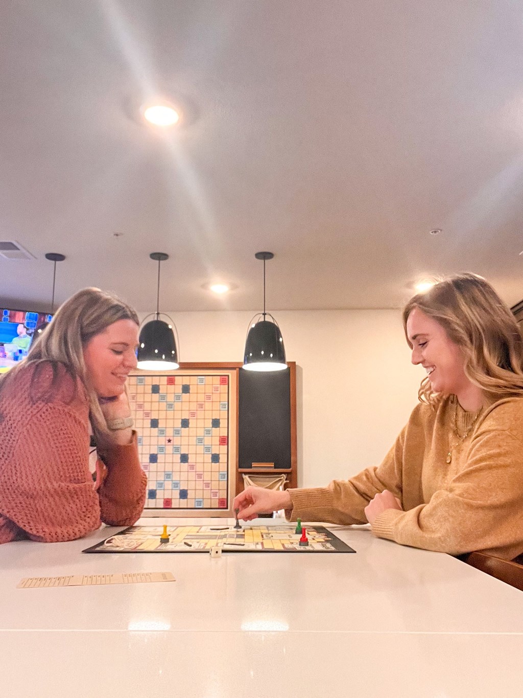 Two women playing a board game together.